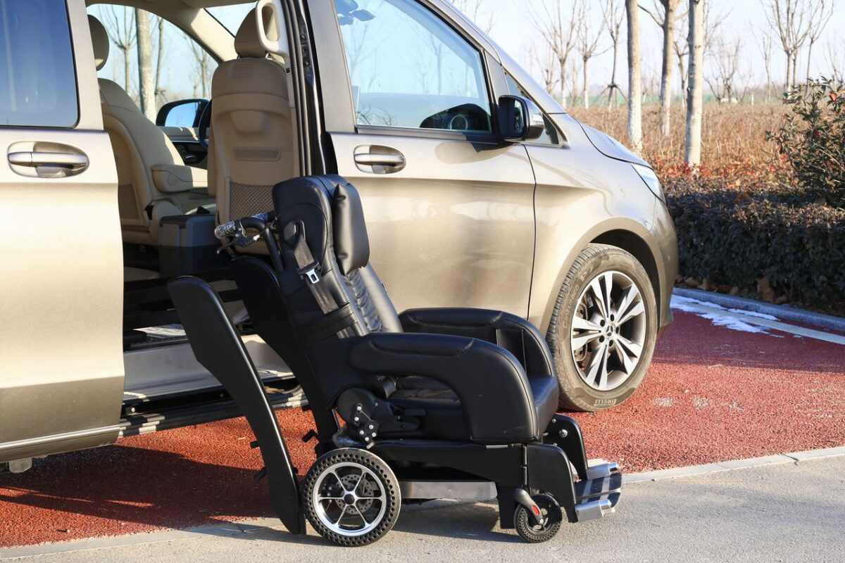 À propos A modern van with an open sliding door showcasing a wheelchair, emphasizing accessibility and convenience.